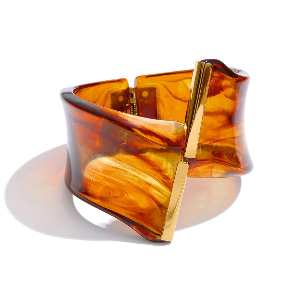 Orange and gold bracelet on a white background