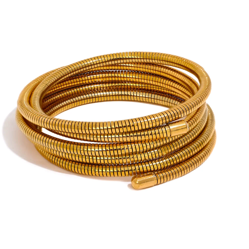Gold coiled bracelet on a white background