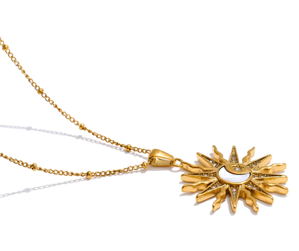 Gold necklace with a sun-shaped pendant on a white background