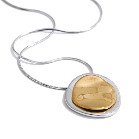 Gold and silver pendant on a white background