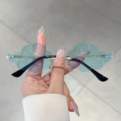 Sunglasses with unique design held by a hand against a neutral background