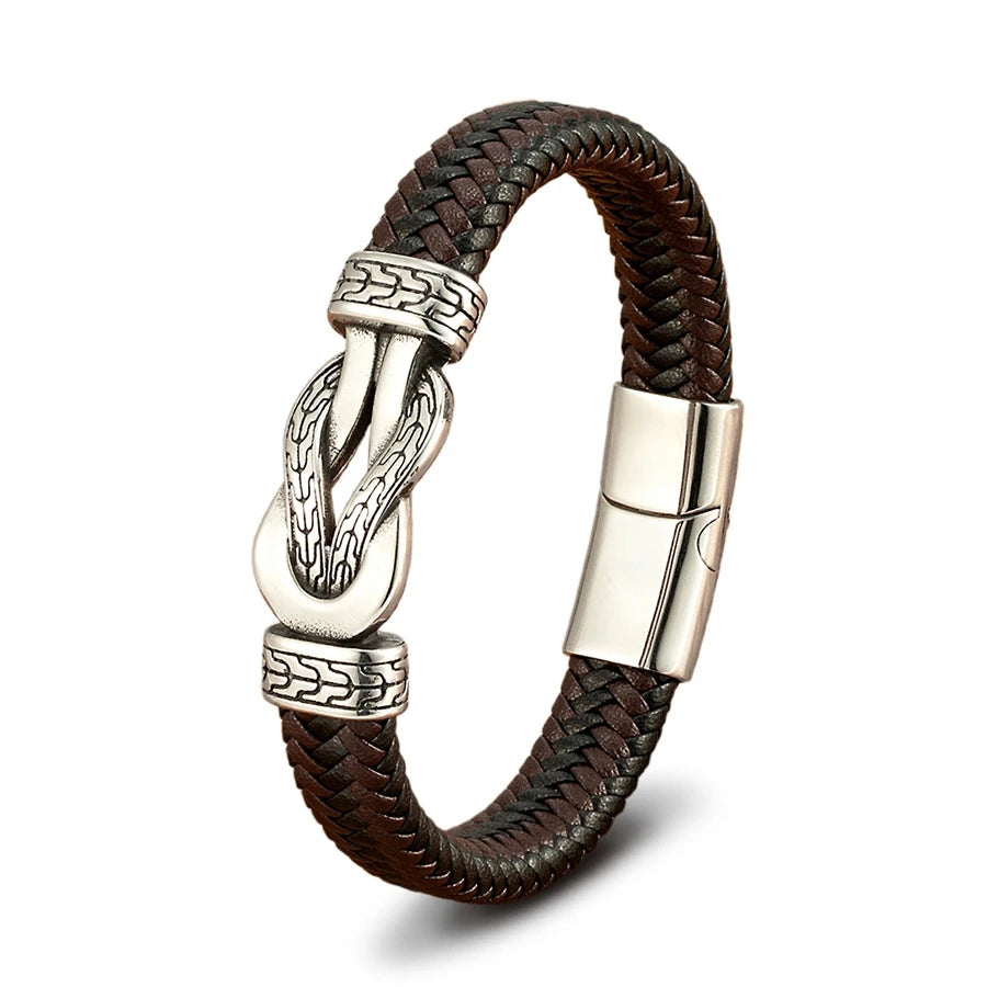 Brown braided leather bracelet with silver metal clasp on a white background