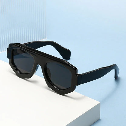 Black sunglasses on a white and light blue geometric background