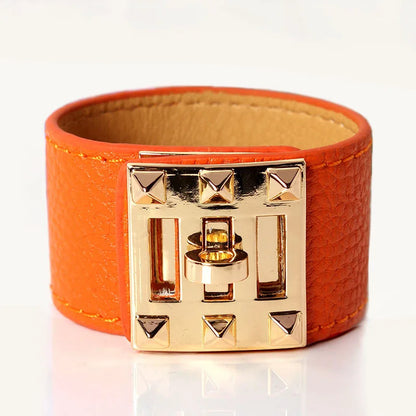 Orange leather bracelet with gold clasp on a white background