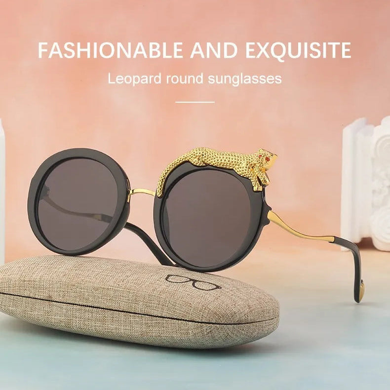 Leopard round sunglasses with gold accents on a light surface