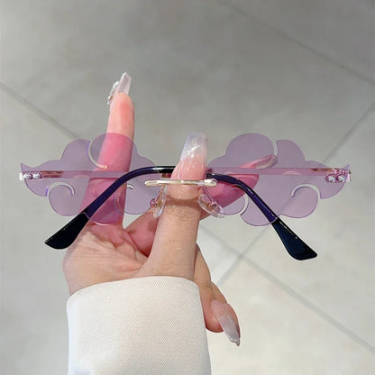 Sunglasses with purple and black design held by a hand against a neutral background