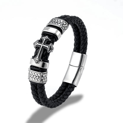 Black braided leather bracelet with silver-tone metal accents, including a cross charm, textured spacer beads, and a magnetic clasp, shown on a white background.