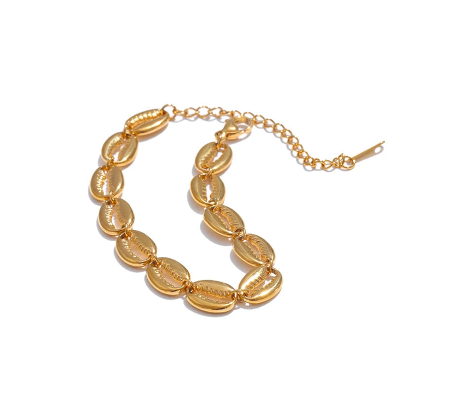 Gold bracelet with shell-like links on a white background