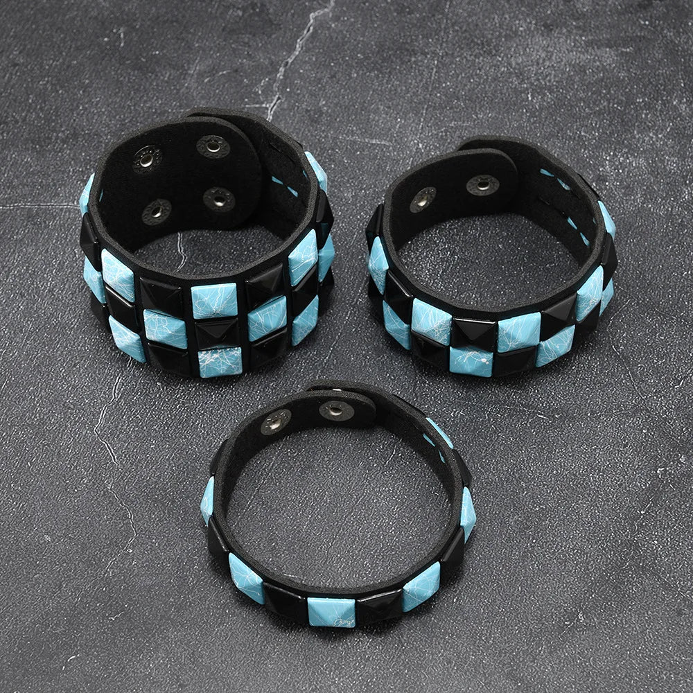 Three black and blue checkered bracelets on a grey surface