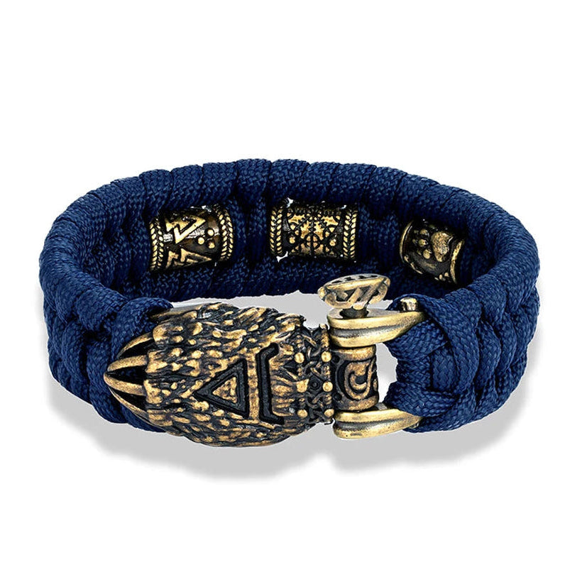 Blue braided bracelet with bronze accents on a white background