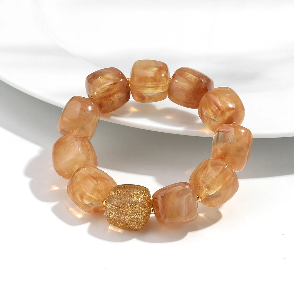 Bracelet with orange beads on a white background