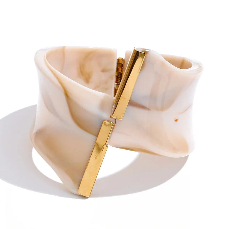 Beige and gold bracelet on a white background.