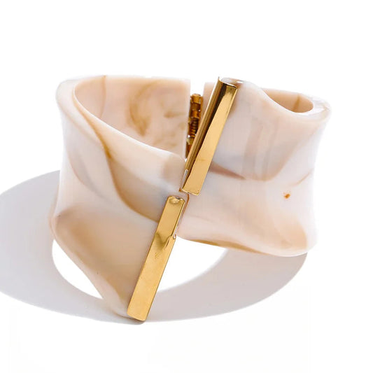 Beige and gold bracelet on a white background.