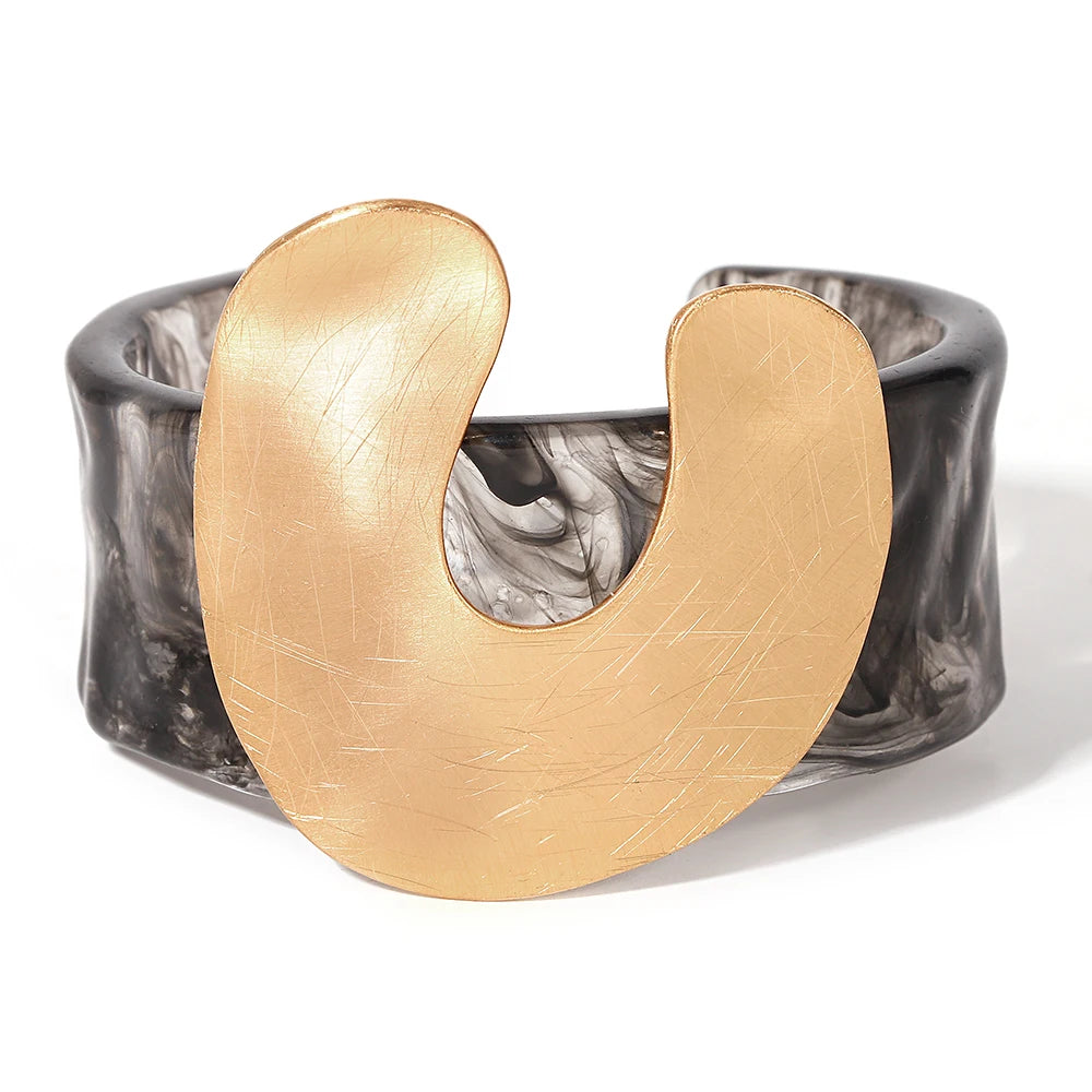 Gold and black bracelet on a white background