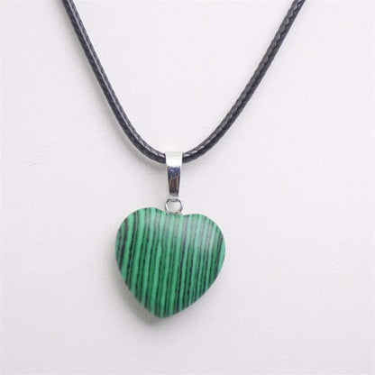 Heart-shaped green pendant on a black cord against a white background