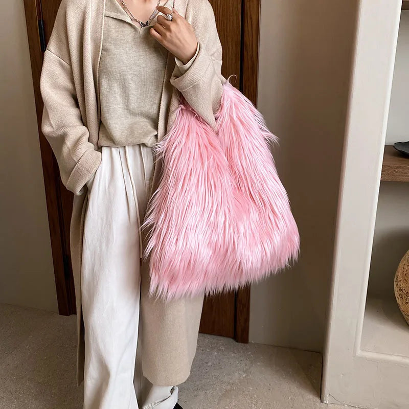 Person holding a pink fluffy bag indoors