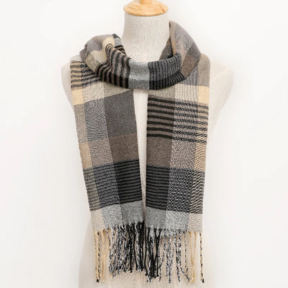 Plaid scarf with fringes on a mannequin against a white background
