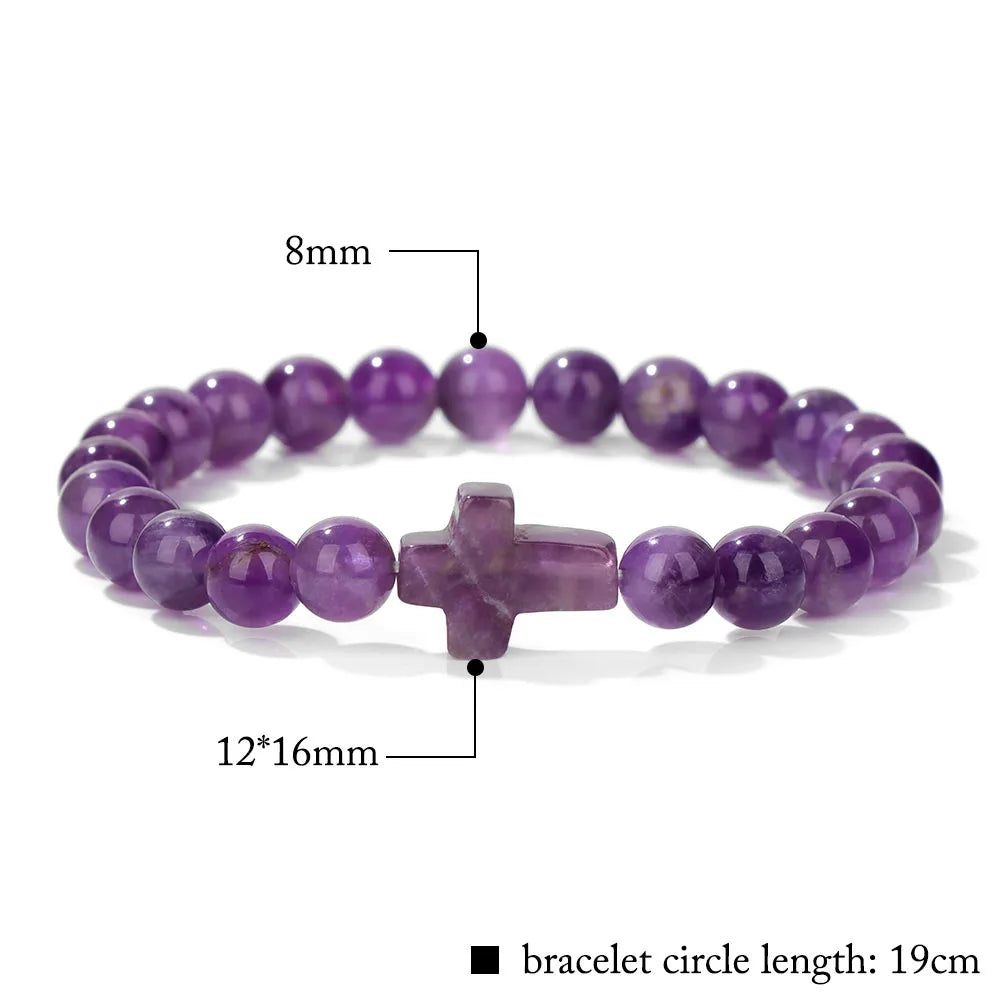 Purple beaded bracelet with a cross charm on a white background, showing measurements.