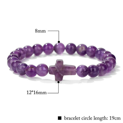 Purple beaded bracelet with a cross charm on a white background, showing measurements.