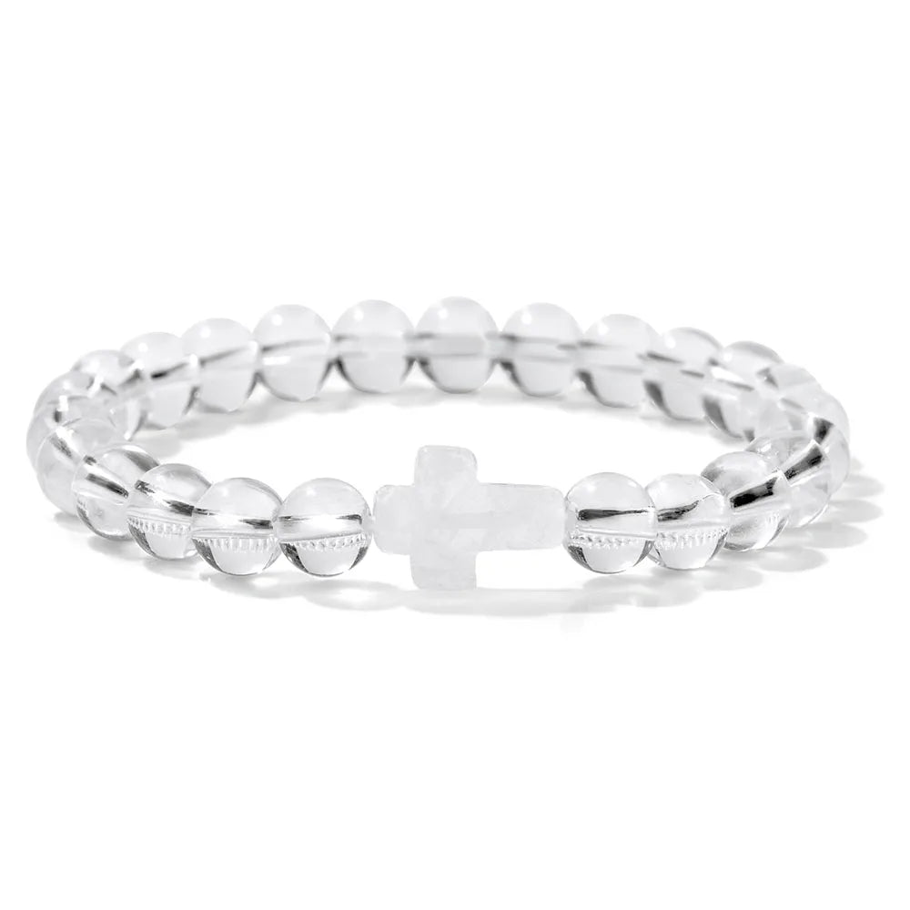 Transparent bracelet with a cross charm on a white background
