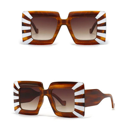 Sunglasses with a tortoiseshell frame and white stripes on a white background