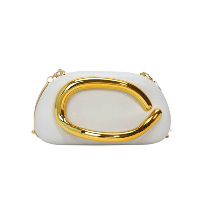 White clutch with gold handle on a white background