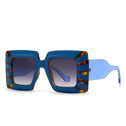 Sunglasses with blue and tortoiseshell frame on a white background
