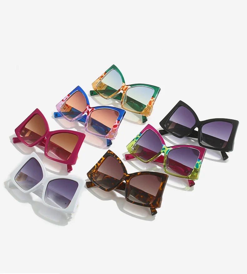 Six pairs of women's cat-eye sunglasses arranged on a light grey background, each with a different frame colour and tinted lens.