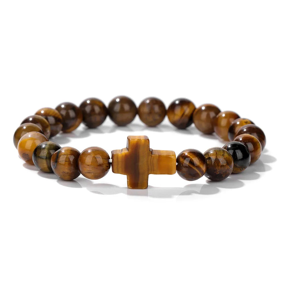 Beaded bracelet with a cross charm on a white background