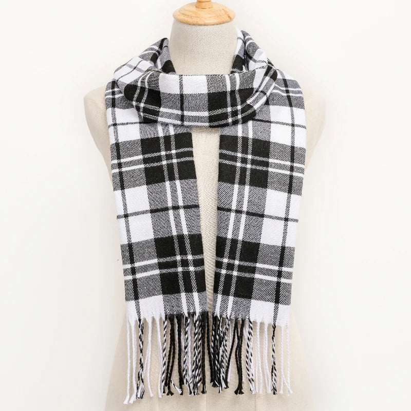 Black and white plaid scarf with fringes on a mannequin against a white background