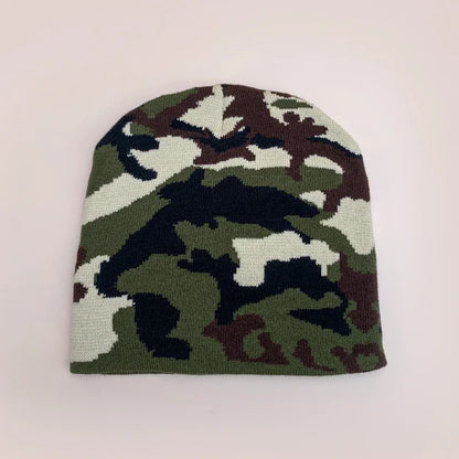 Camouflage-patterned beanie on a light pink background