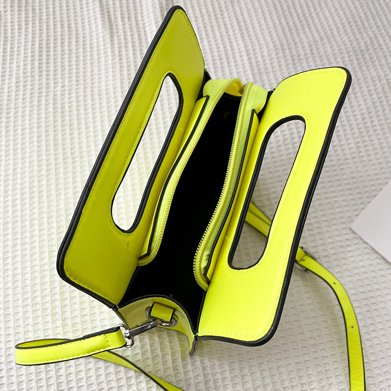 Neon yellow handbag with a textured white background