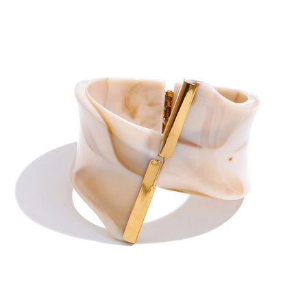 White and gold bracelet on a white background