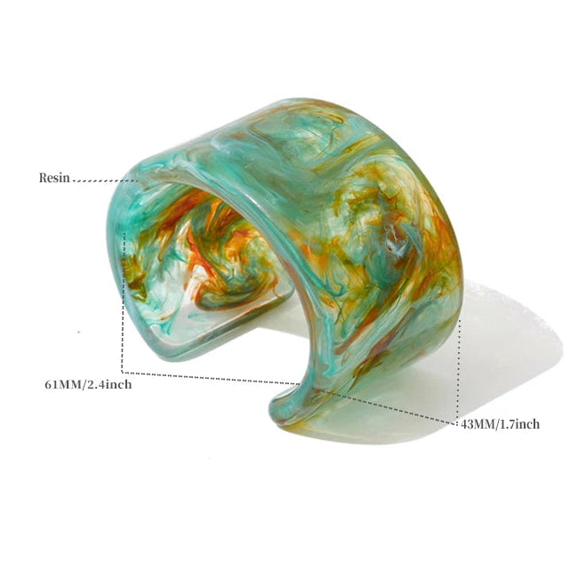Turquoise and gold marbled cuff bracelet with technical details on a white background
