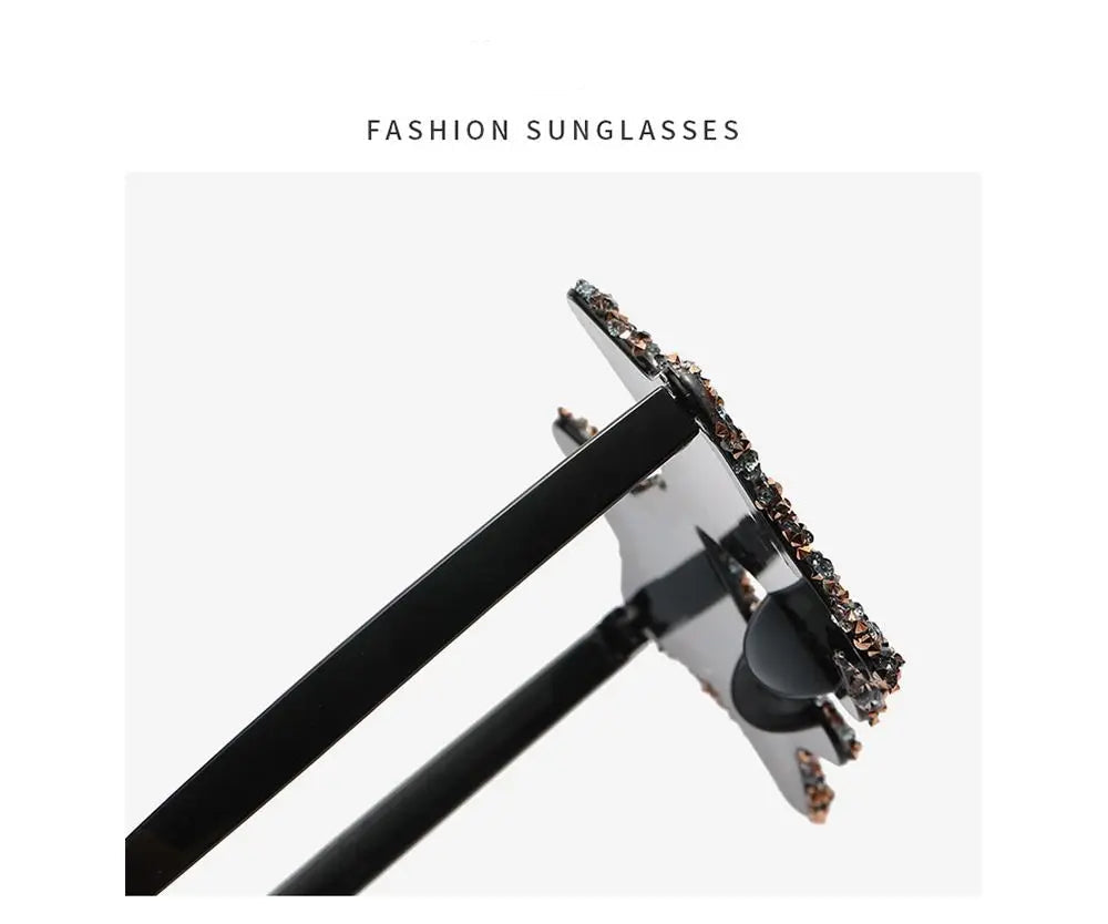 Fashion sunglasses with black frame and decorative elements on a white background