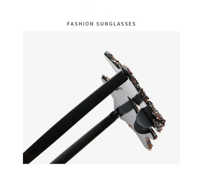 Fashion sunglasses with black frame and decorative elements on a white background