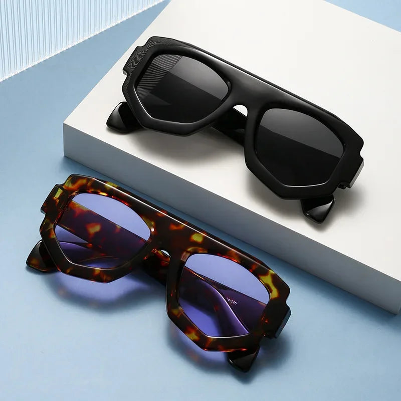 Two pairs of sunglasses, one black and one with tortoiseshell frame and purple lenses, on a light blue and white geometric background.