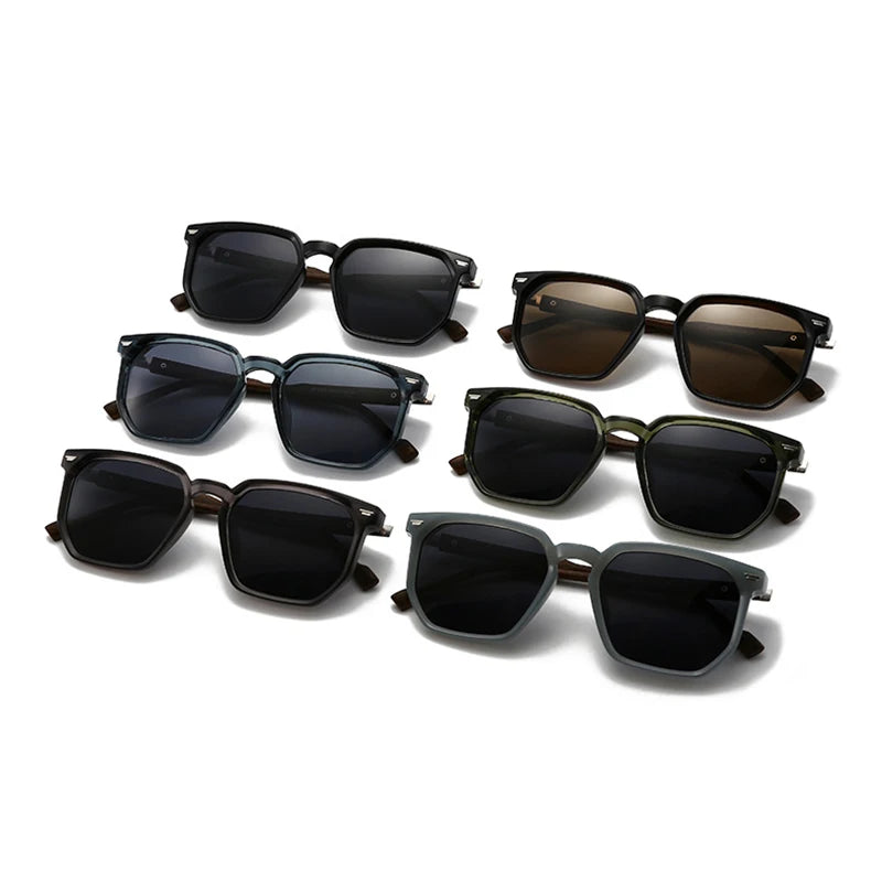 Set of six pairs of sunglasses with different lens colours on a white background