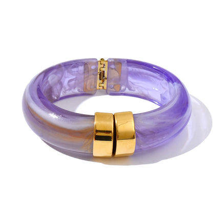 Purple marbled bracelet with gold accents on a white background