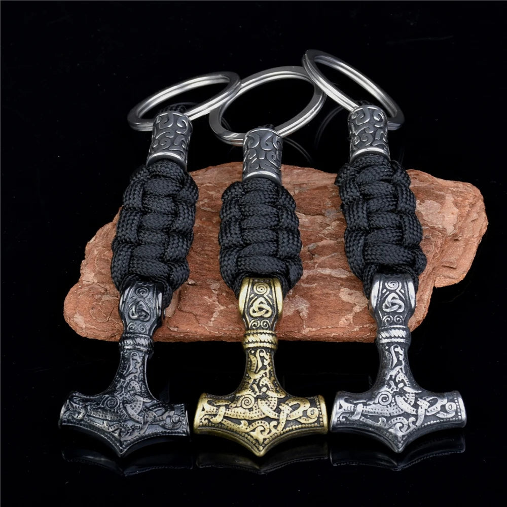 Three Viking-style keychains with decorative handles on a dark background