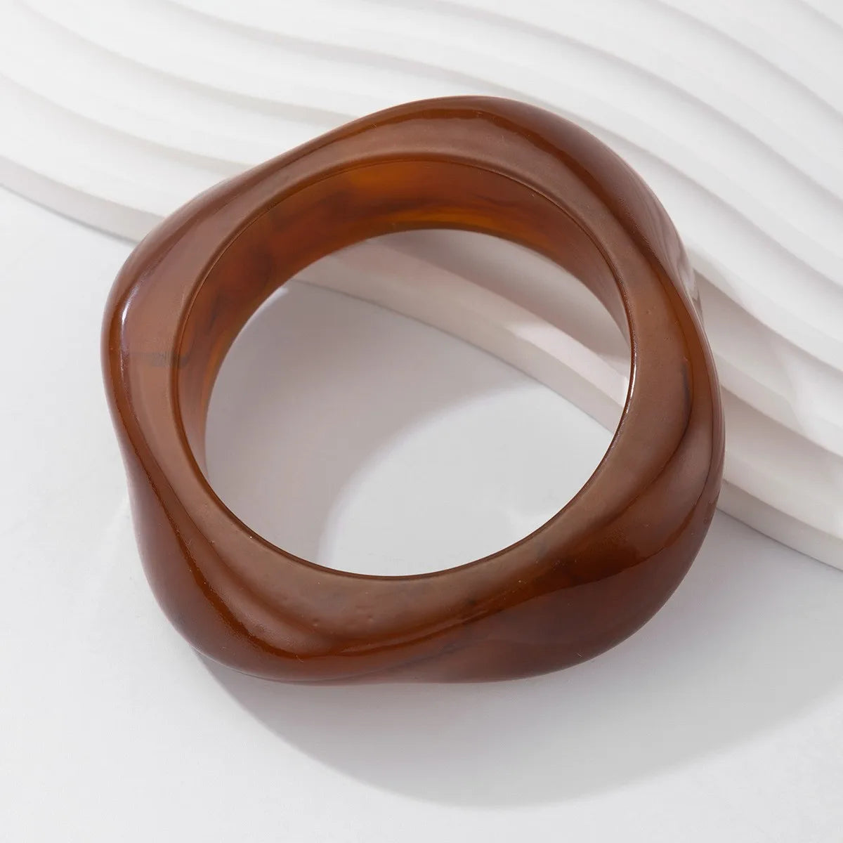 Brown resin bangle on a white background