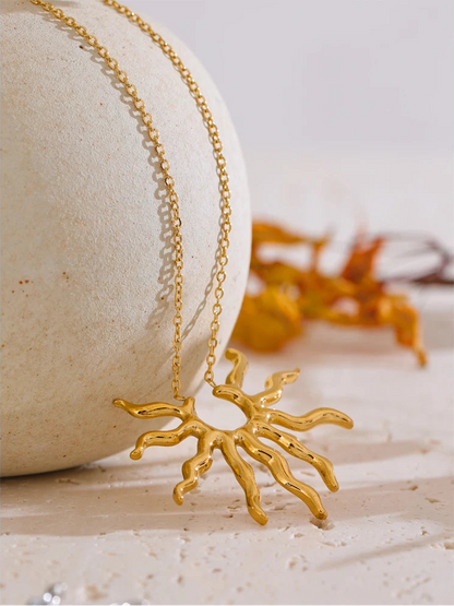 Gold necklace with a unique pendant on a textured surface