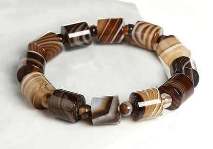 Banded agate bracelet on a white background.