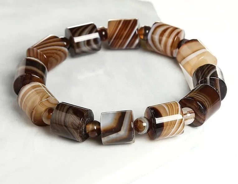 Banded agate bracelet on a white background.
