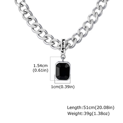 Silver chain necklace with a black pendant on a white background