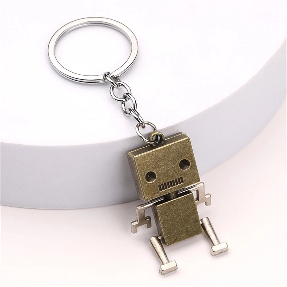 Gold metal robot keyring on white background