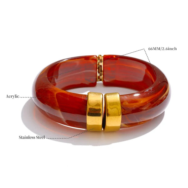 Brass bracelet with gold accents on a white background
