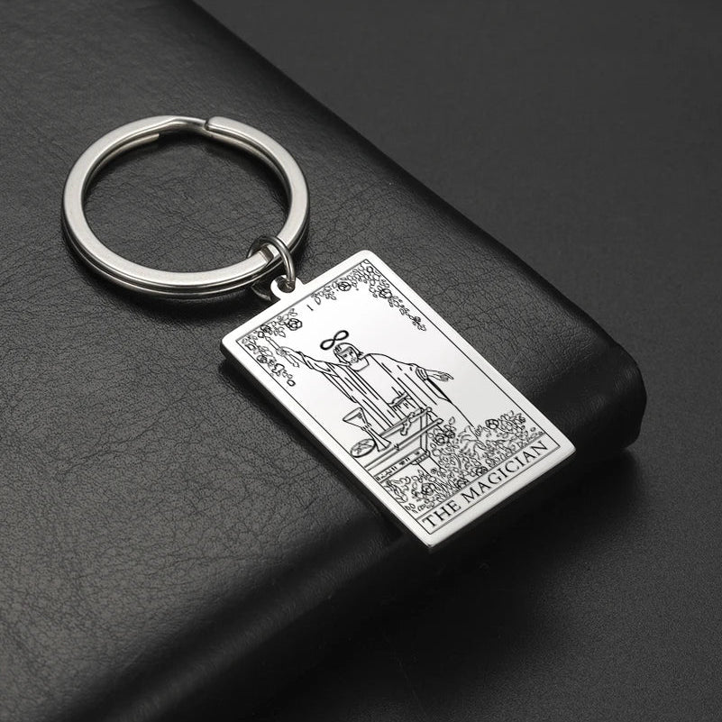 Keychain with tarot card design on a dark surface