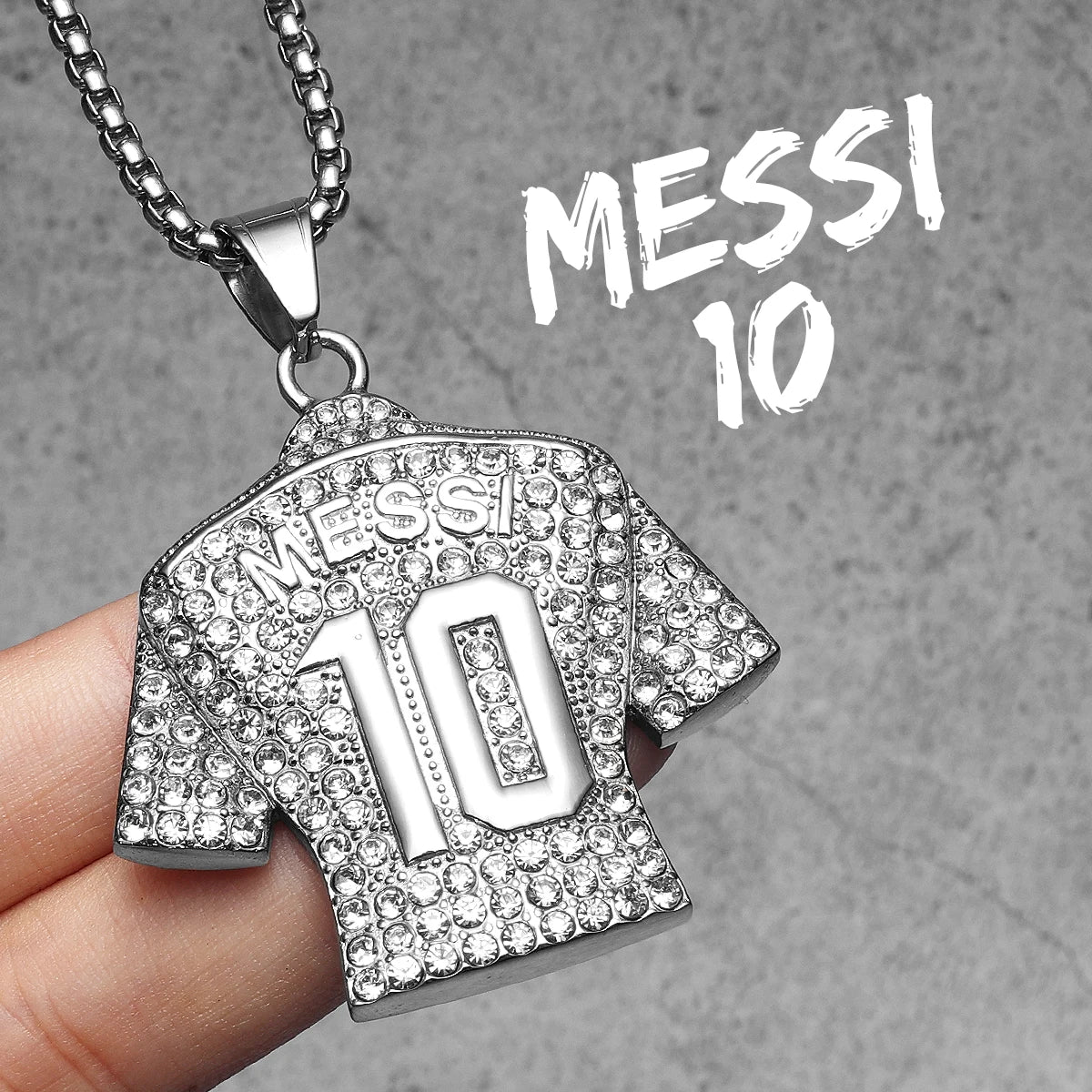 Silver pendant shaped like a sports jersey with 'Messi 10' text on a grey background