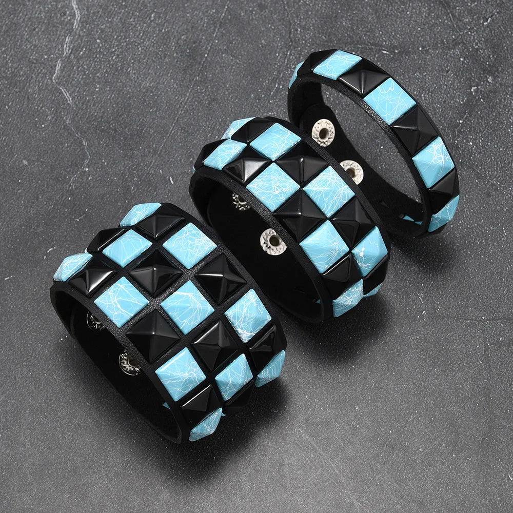Two black and blue checkered bracelets on a grey surface
